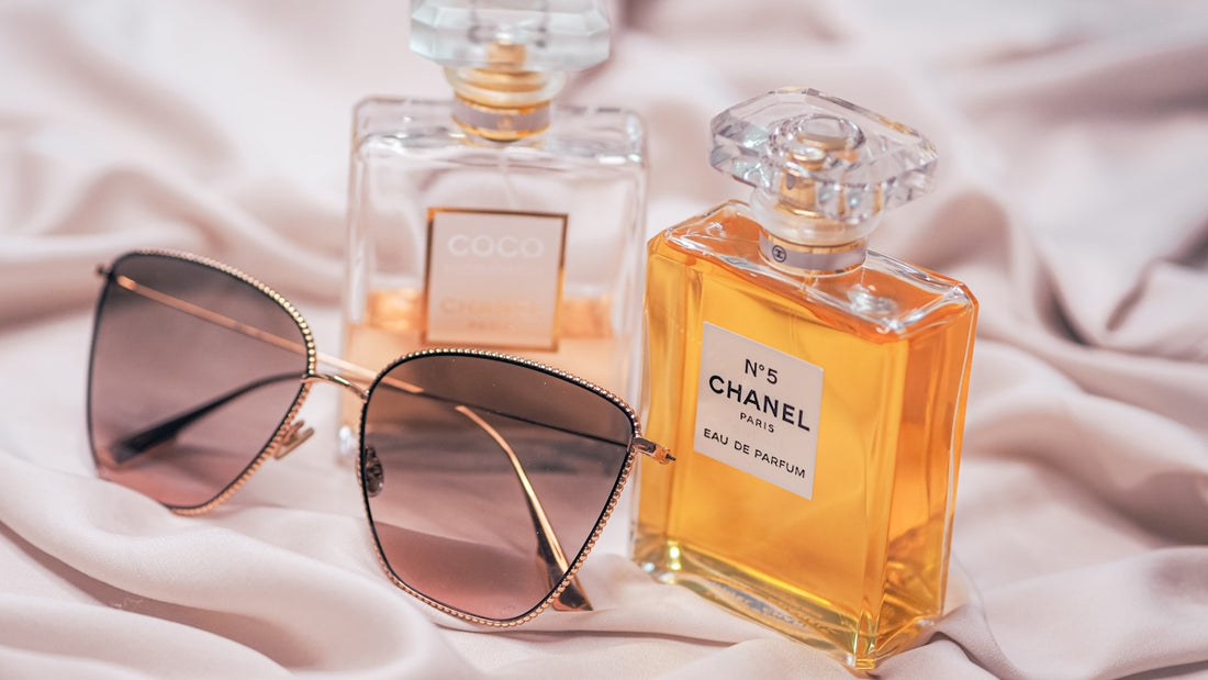 black sunglasses beside glass bottle