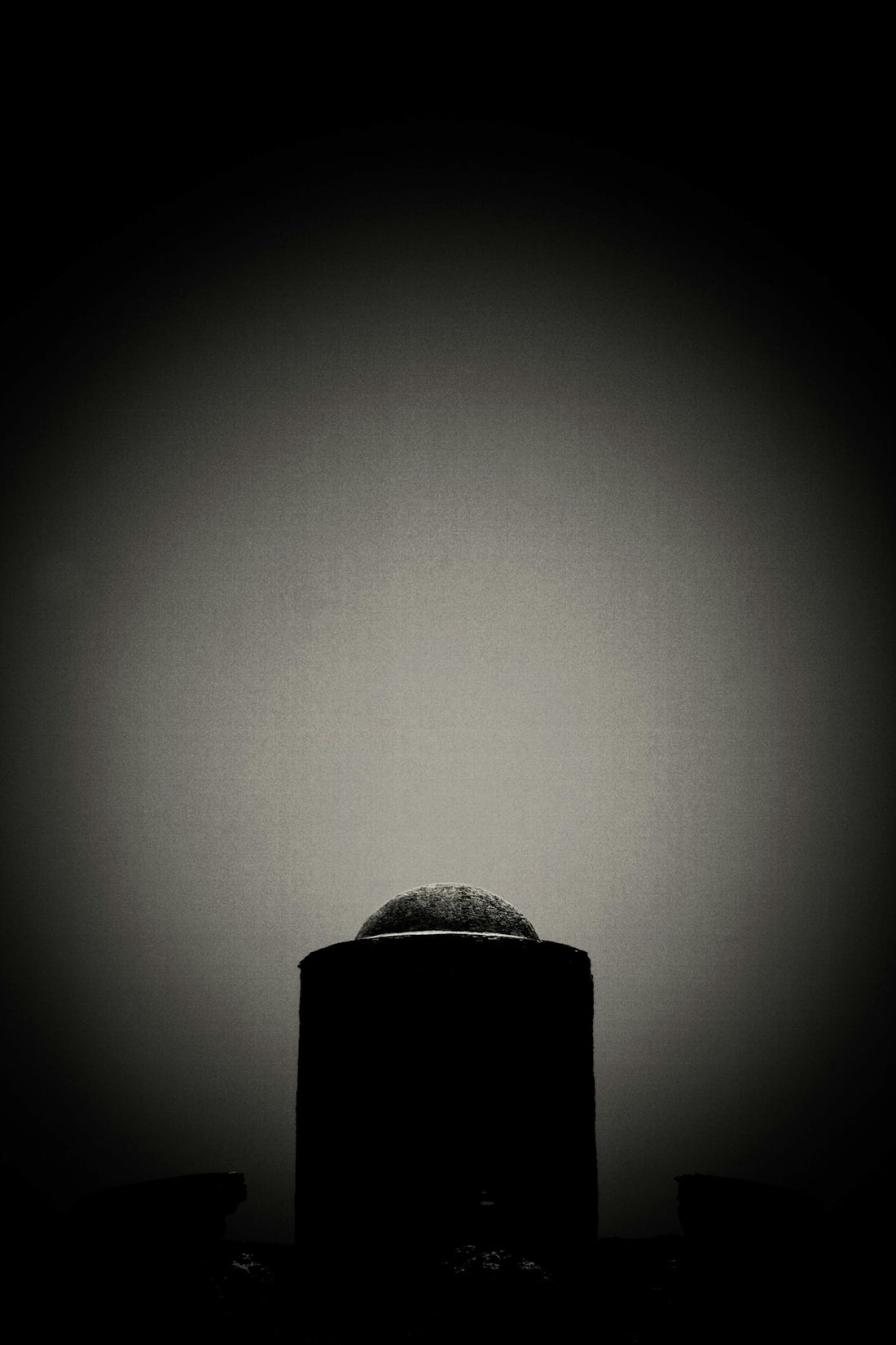 a black and white photo of a round object