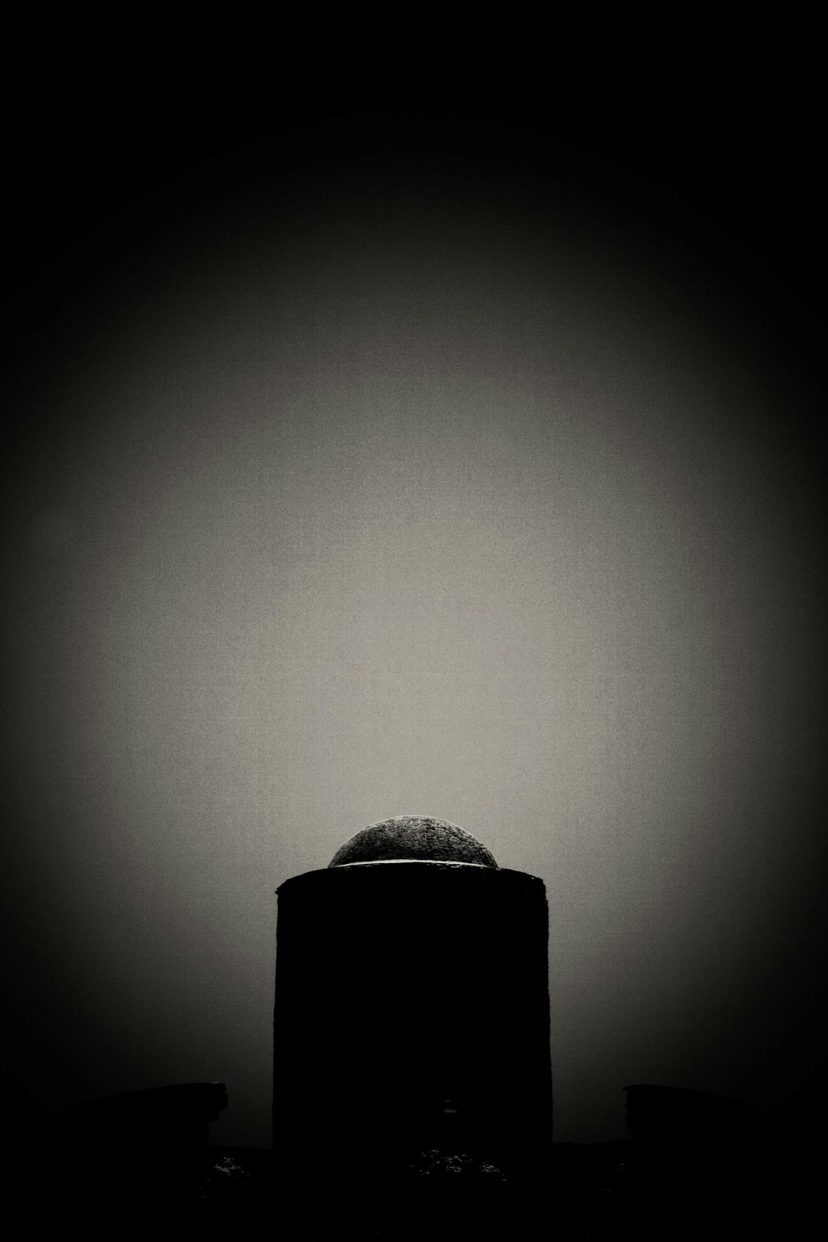 a black and white photo of a round object