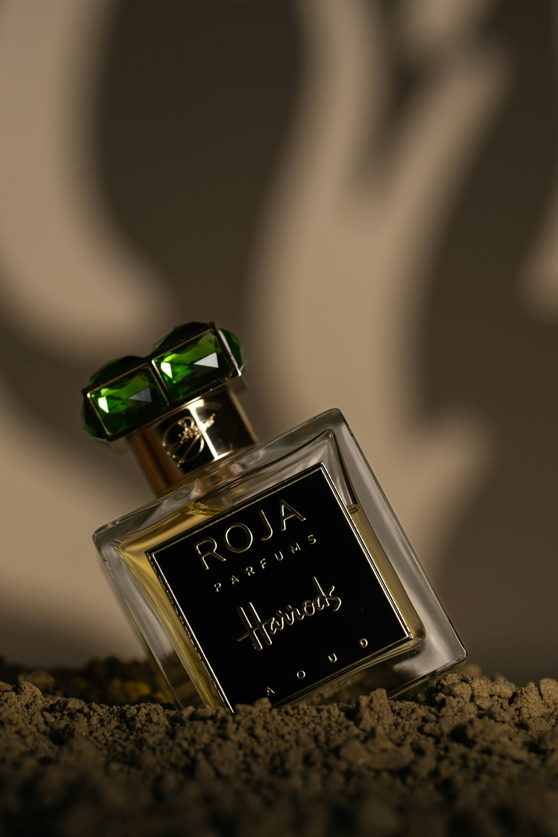Luxury perfume bottle with green gemstone cap