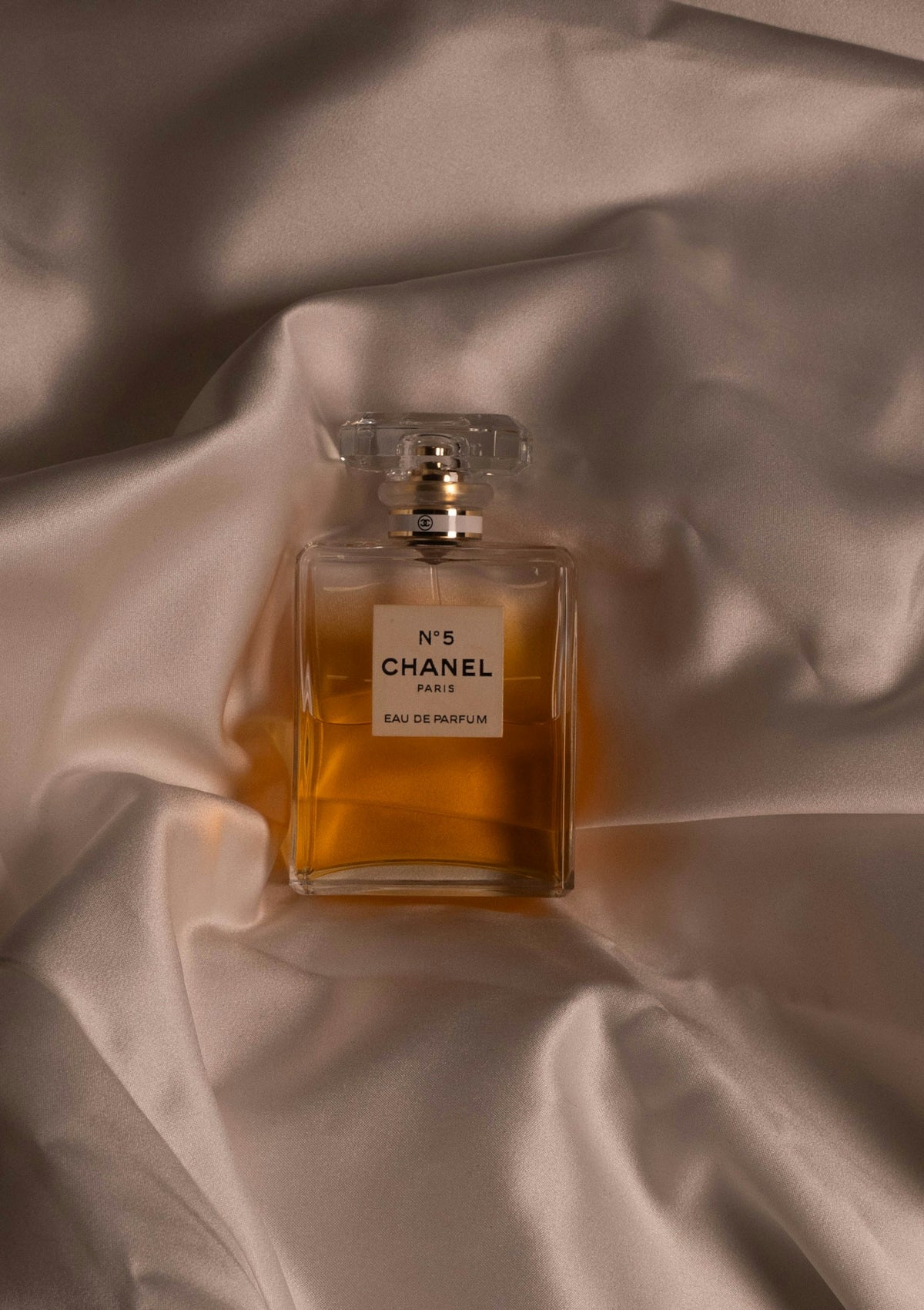 Chanel no. 5 perfume bottle on satin fabric