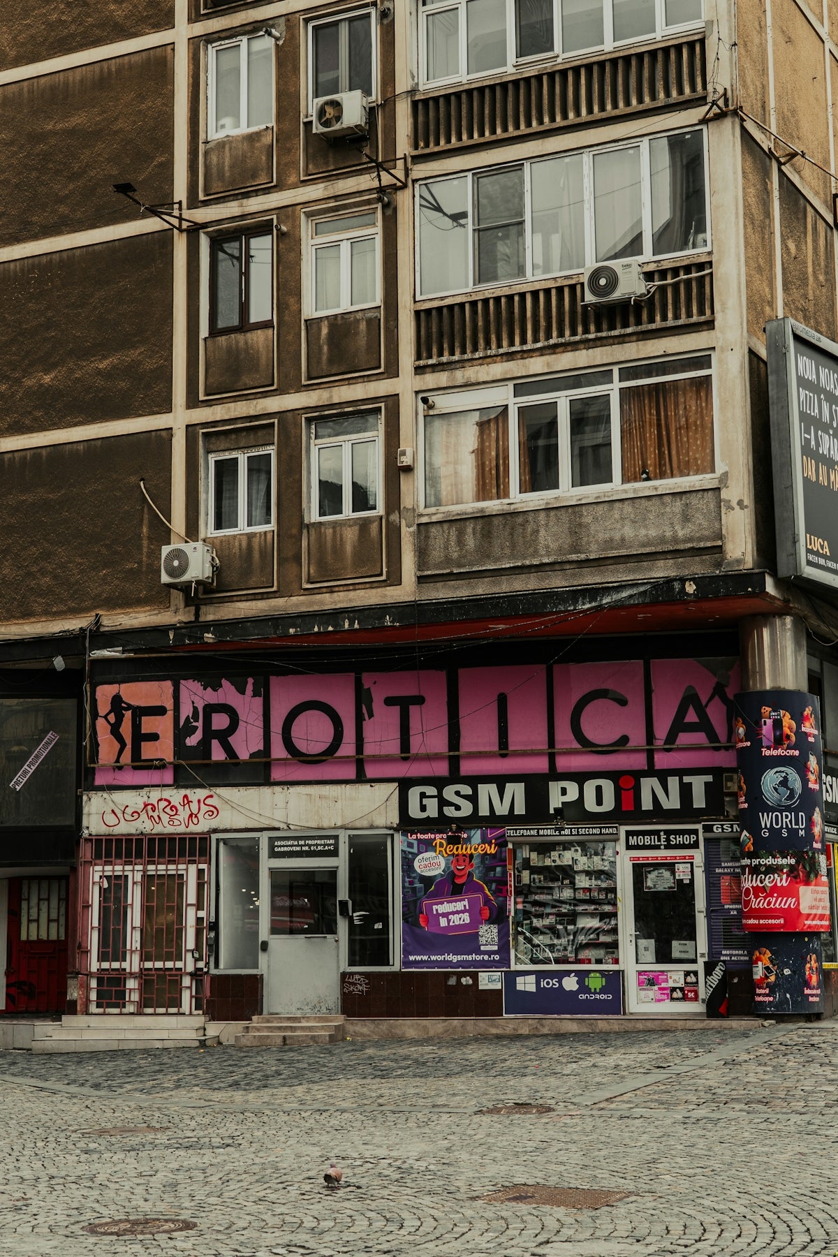 An erotica store with a gsm point below apartments.